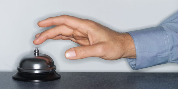 Image of hand ringing a concierge bell depicting the need for customer service in I.T.