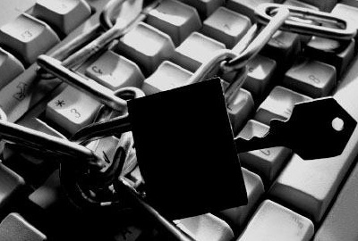 Computer keyboard with chain and padlock to punctuate the need for asset management policies.