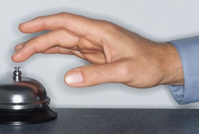 Image of hand ringing a concierge bell depicting the need for customer service in I.T.
