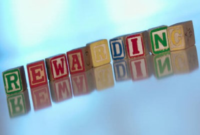 Image of children's alphabet blocks spelling the word 'rewarding' indicating the need to define project deliverables will produce rewarding results.